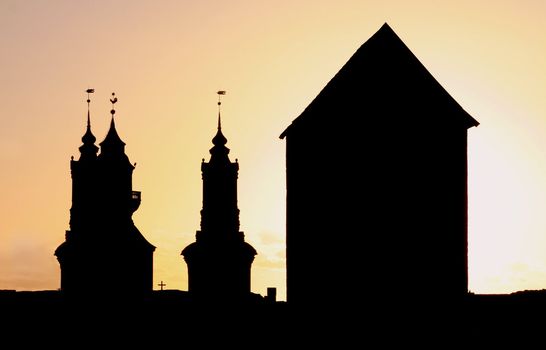 Silhouettes of a Church and a huge Tower.