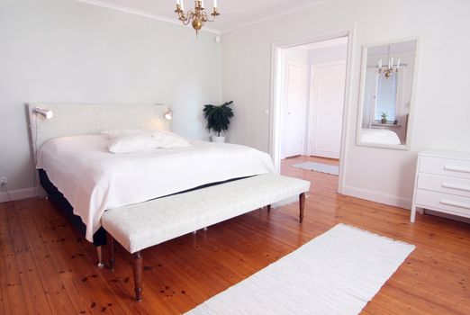 Modern fresh bedroom in white colors.