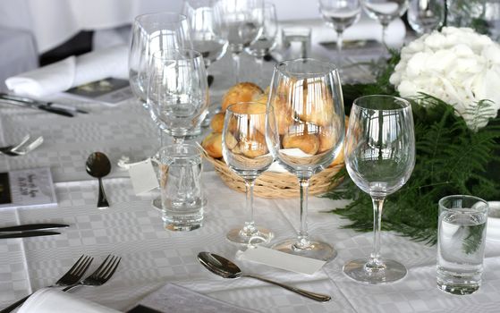 Table setting of wedding. Dining table with classy glasses.