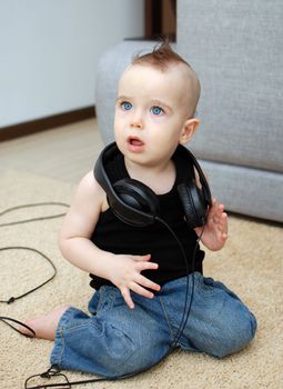 Portrait of serious baby in the earphones
