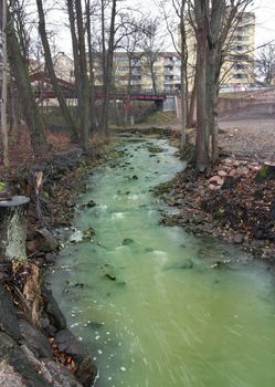 Green Polluted River in urban environment.