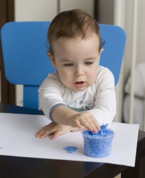 baby play with blue plasticine