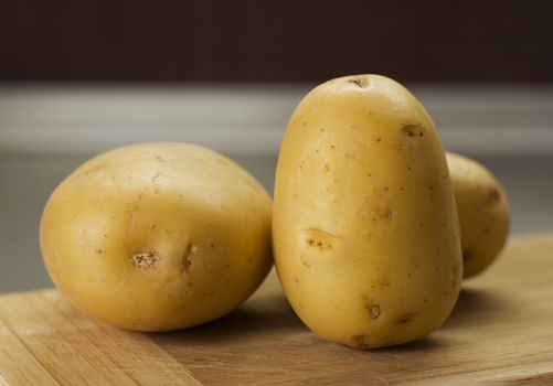 group of potatoes on breadboard indoor