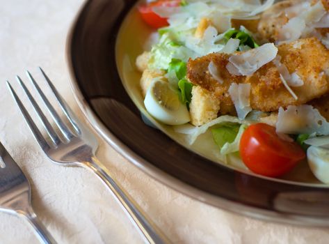 Chicken or Caeser Salad in a bowl with lettuce, cheese and fired chicken