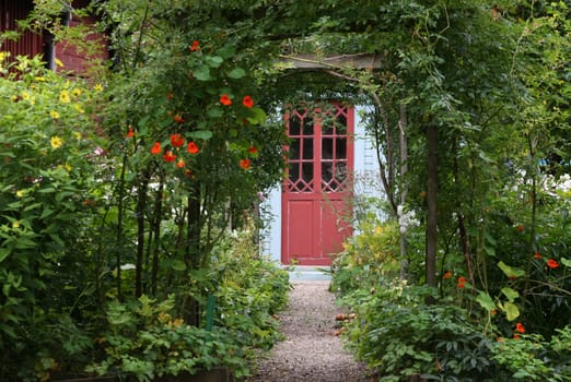 Lush green garden in front of building entrance.