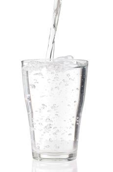 fresh water pouring into a glass isolated on white background 