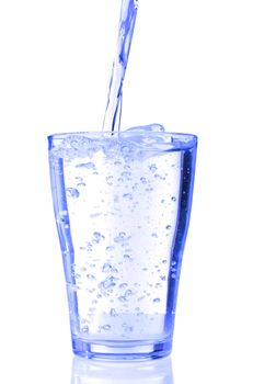 fresh water pouring into a glass isolated on white background