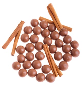 cereal chocolate balls and cinnamon sticks (isolated on white background)