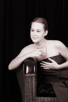 Beautiful female wrapped in fabric, wearing pearls