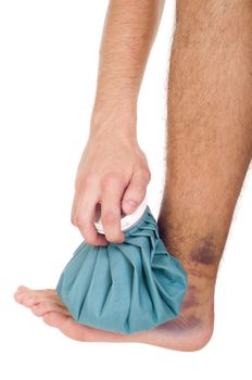 young male icing a sprained ankle with ice pack (isolated on white background)