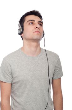 quiet casual young man listening music on headphones (isolated on white background)