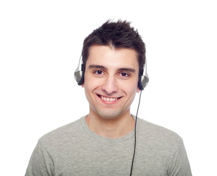 smiling young man listening music on headphones (isolated on white background)