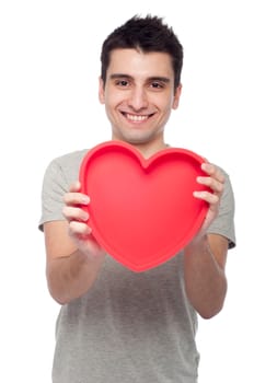 lovely portrait of a young man holding a red heart (isolated on white background)