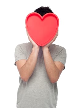 lovely portrait of a young man holding a red heart (isolated on white background)