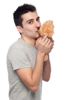lovely portrait of a young man kissing a teddy bear (isolated on white background)
