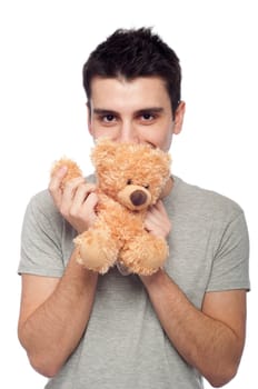 lovely portrait of a young man cuddling a teddy bear (isolated on white background)