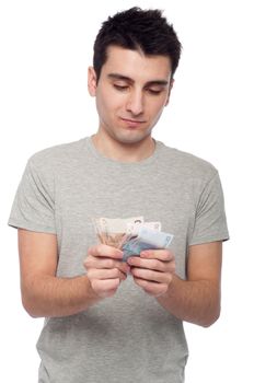 quiet young man looking at his money, euro bills (isolated on white background)