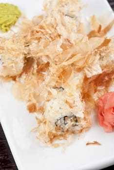 Sushi rolls of rice, nori, cream cheese, avocado, smoked salmon,cucumber and cuts of tuna