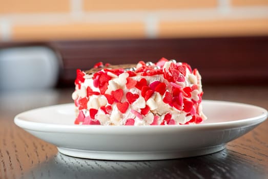 fresh baked cupcake with hearts on a wooden table