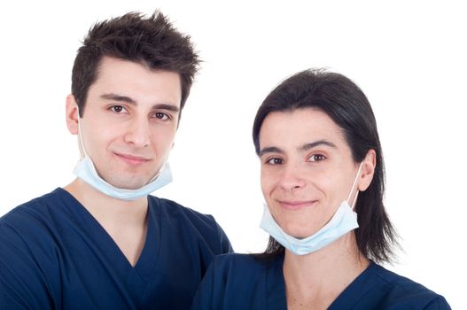 closeup portrait of a team of doctors, man and woman wearing mask and uniform isolated on white background