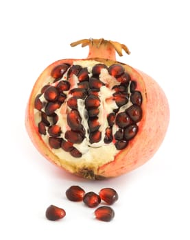 Pomegranate cut open showing seeds, isolated on white