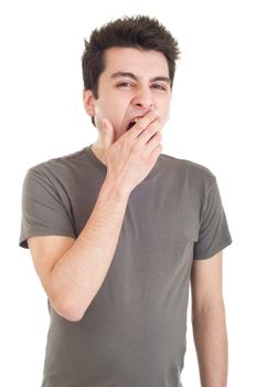 exhausted young man yawning isolated on white background