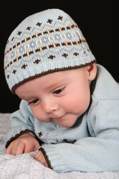 Cute four month old baby boy lying on his tummy