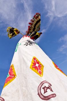 A pair of Native American tee pee and skyline