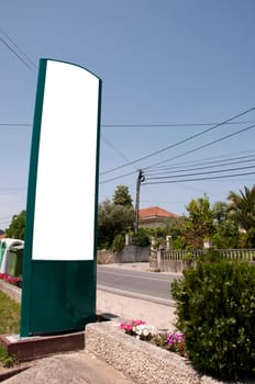 empty billboard next to a road on a rural area (blue sky)