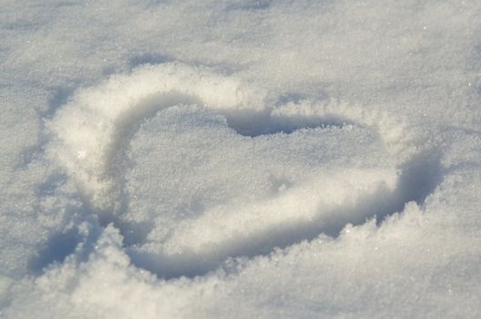 Sign of heart written on snow