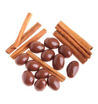 chocolate coated almonds and cinnamon sticks (isolated on white background)