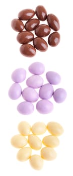 collection of chocolate coated almonds (brown, purple, white) isolated on white background