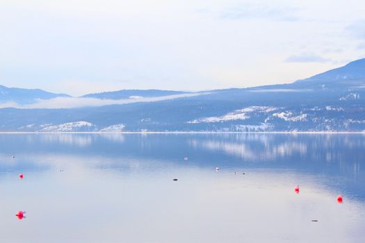 Reflection of Mountain on lake with buoys