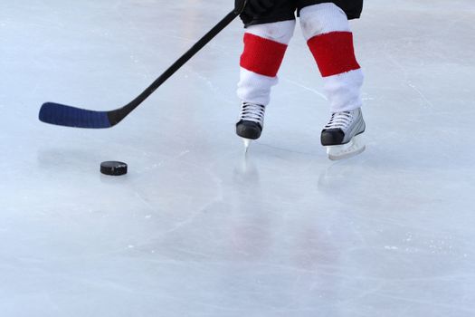 Young hockey player practising on a frozen pond