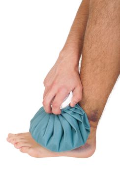 young male icing a sprained ankle with ice pack (isolated on white background)