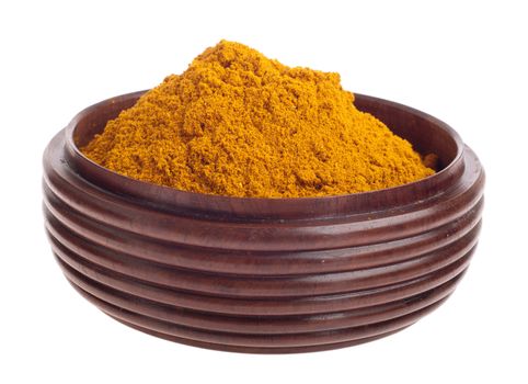 curry powder, mix of indian spices on a vintage wooden bowl (isolated on white background) 