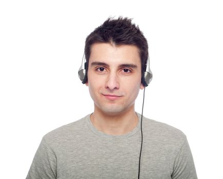 casual young man listening music on headphones (isolated on white background)