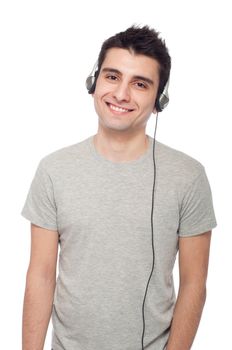 smiling young man listening music on headphones (isolated on white background)