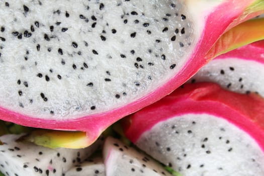 Pink pitahaya dragon fruit background sliced in pieces