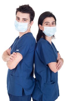 back to back portrait of a team of doctors wearing mask and uniform isolated on white background