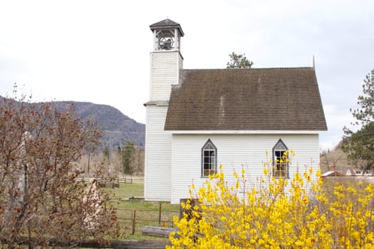 Old wooden church surrounded by small cemetry