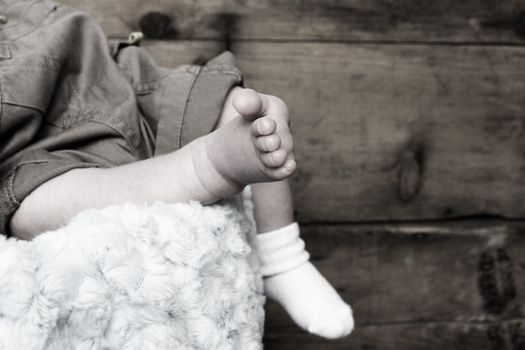 Newborn baby foot with other foot in sock