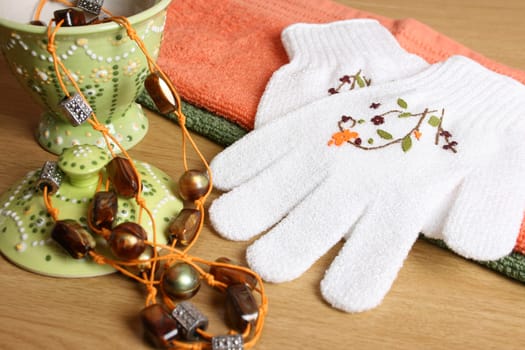 Spa Accessories setting with face cloths, jewelery and glove