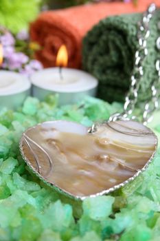 Beautiful shell heart necklace with spa accessories in the background