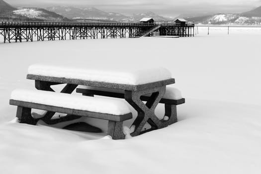Snow covered picnic bench at Salmon Arm Pier, BC, CANADA