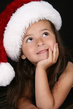 Beautiful little brunette girl dreaming about christmas