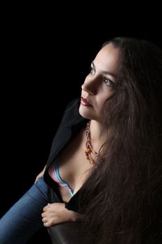 Portrait of young brunette female against dark background