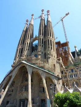 View of the facade of the Sagrada familia cathedral, Barcelona, Spain. The building of this cathedral strated in 1882 by famous architect Antoni Gaudi and is not finished yet. Its style is neogothic. In 2005, Unesco entered this cathedral in worl heritage.