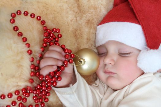 Baby boy wearing a christmas hat sleeping sound