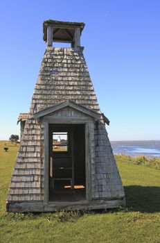 See the Lighthouse through playhouse, Woods Island, PEI, Canada